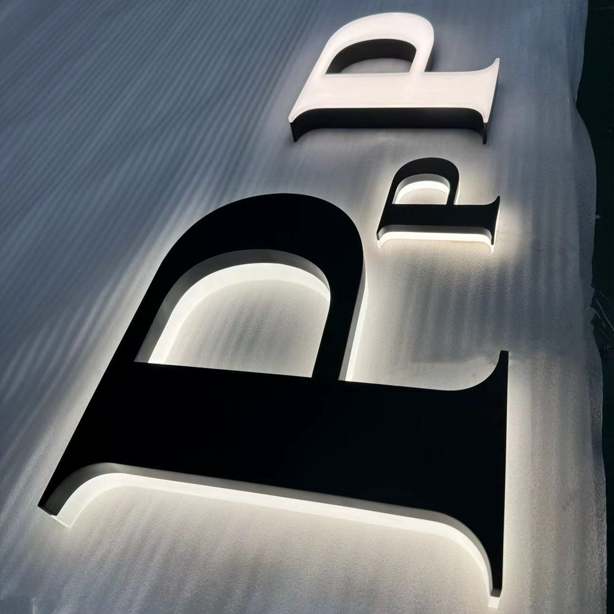 Custom painted stainless steel 3D letters reverse lit channel letters exterior company wall brand signs